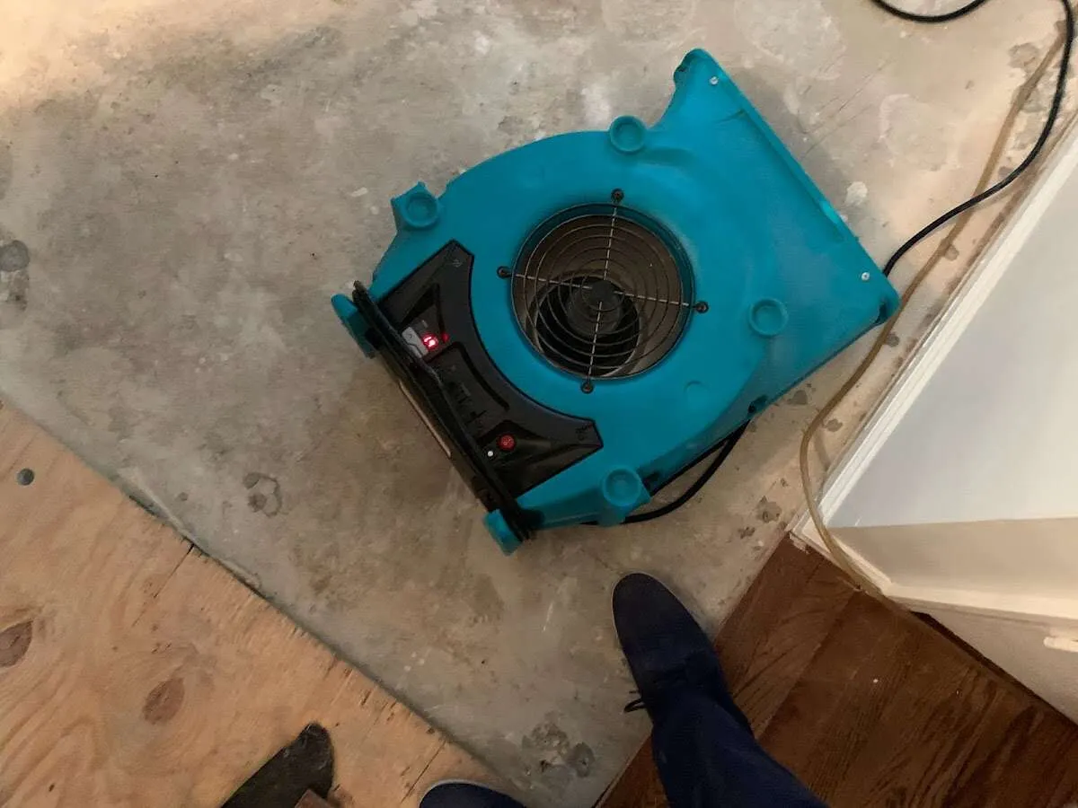 Air mover drying subfloor during Commercial Water Damage Restoration in Ceres